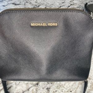 Michael kors black and gold cross over handbag.